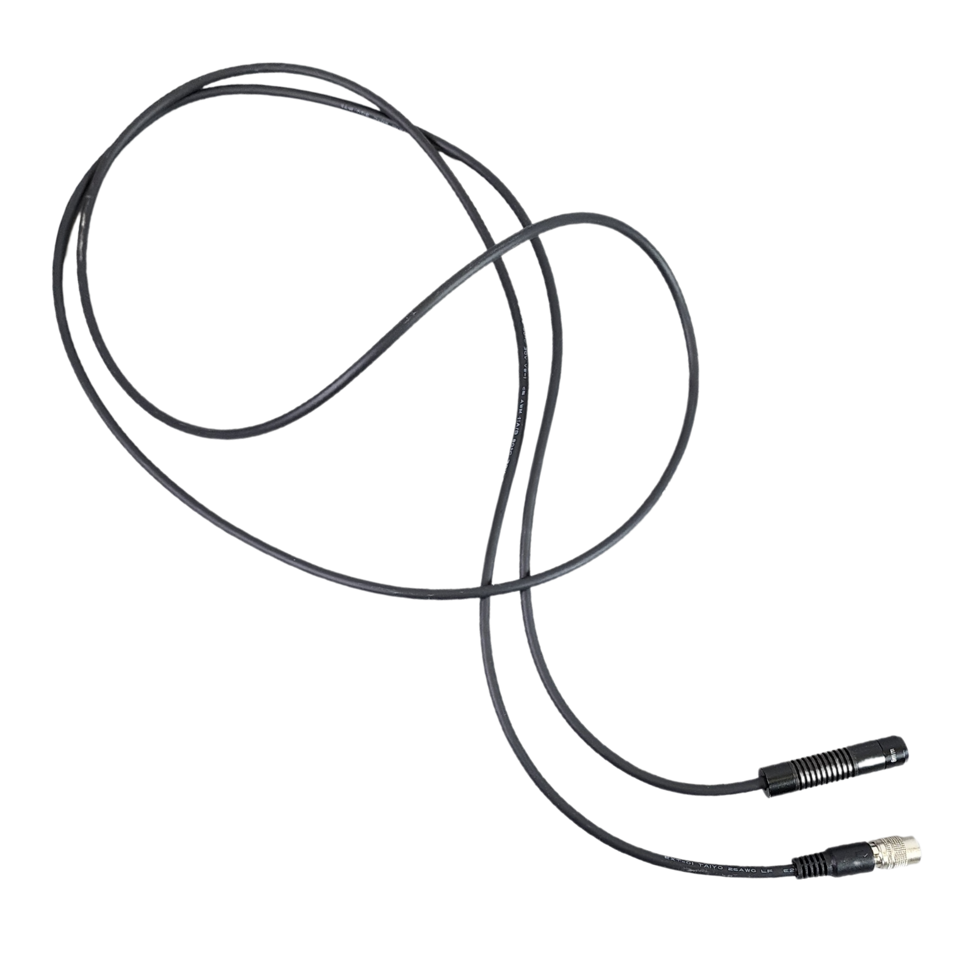 Coiled black cable with connectors on a white background